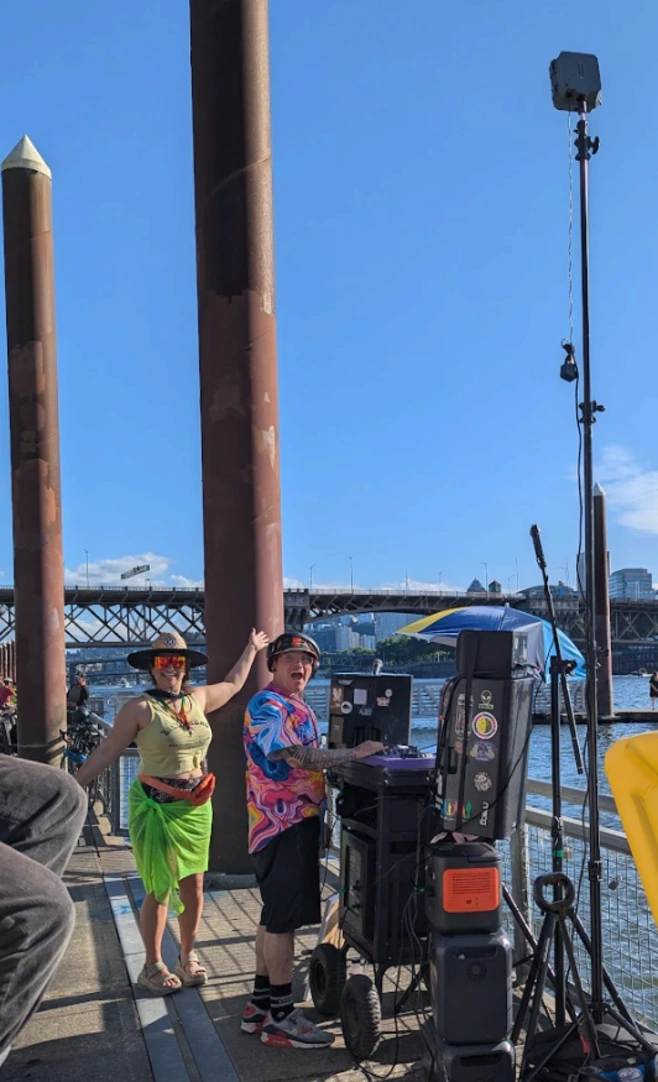 traffic monitor on tripod for a dj on the dock event near the river